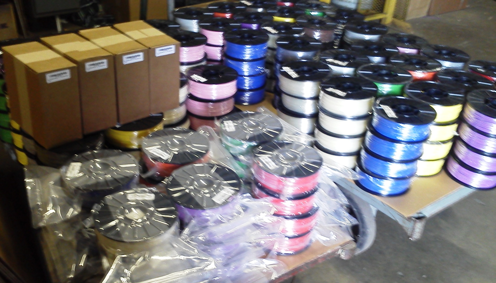 Colorful 3D printer filament spools packaged for shipping